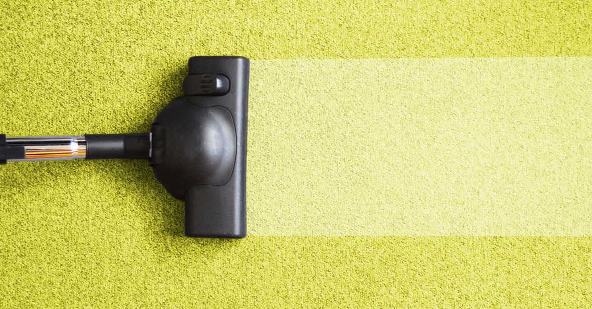 a photo of a green carpet getting cleaned